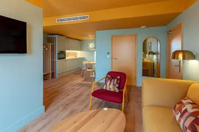 a living room with a couch and a table at SeaSpace in Newquay
