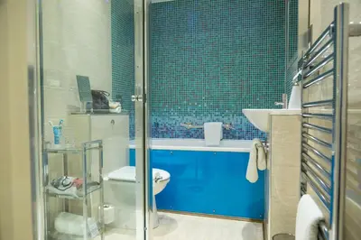 a bathroom with a shower and a toilet and a sink at Bosanneth in Falmouth