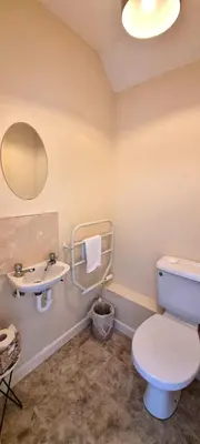 a bathroom with a toilet and a sink at Sand Dunes in Perranporth