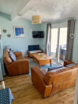 a living room with two couches and a table at Pensilva in Hayle