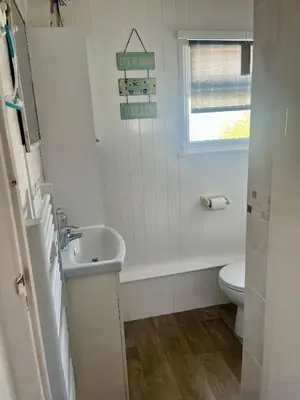 a white bathroom with a sink and a toilet at Pensilva in Hayle