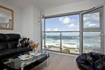 a living room with a view of the ocean at 5 Fistral Beach, Newquay in Newquay