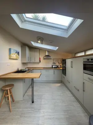 a large kitchen with a skylight in the ceiling at Michaelstow in Perranporth