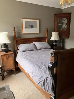 a bedroom with a bed with two night stands and two lamps at Michaelstow in Perranporth