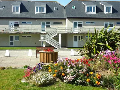 a group of flowers in front of a building at 7 Penhale in Perranporth