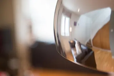 a reflection of a person in a mirror at Warwick Lodge in Perranporth