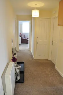 a hallway of a home with a white refrigerator at King Arthurs Arms in Tintagel