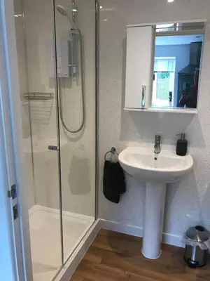a bathroom with a sink and a shower at Talland Studio in St Ives