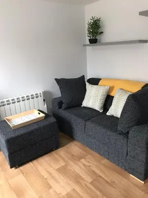a living room with a couch and a chair at Talland Studio in St Ives
