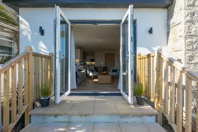 an open door to a house with a porch at Sea Scapes in St Ives