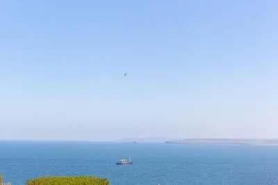 a boat in the middle of a large body of water at Sea Scapes in St Ives
