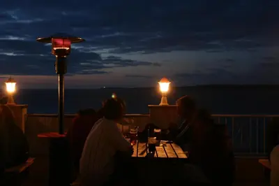 a group of people sitting at a table with wine glasses at St Christopher's Inn Newquay in Newquay