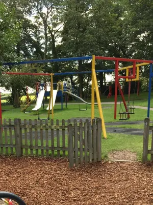 a park with a fence and a playground at Newquay Villa 127 in Newquay
