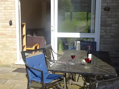 a black table with two glasses of wine on it at Newquay Villa 127 in Newquay