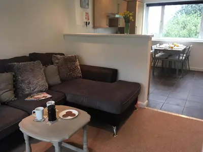 a living room with a couch and a table at Newquay Villa 127 in Newquay