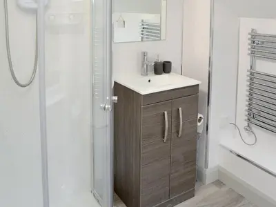a bathroom with a sink and a shower at The Nest in Uny Lelant