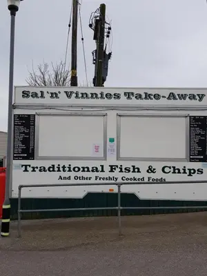 a sign for a fish and chips restaurant and other frequently quoted foods at Caravan Willerby Rio in Looe