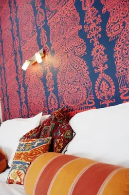 a bedroom with a bed with a blue and red wall at The Gallery in Port Isaac