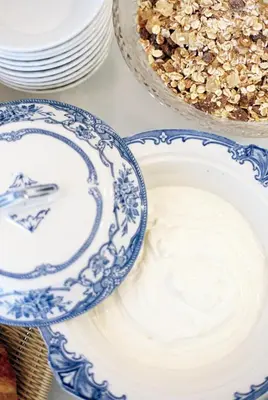 a table with blue and white plates and a cake at Trevose Harbour House in St Ives