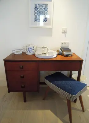 a wooden desk with a plate on top of it at Trevose Harbour House in St Ives