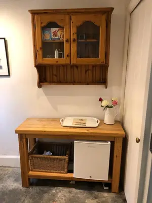 a wooden table with a sink and a cabinet at Samphire in Padstow