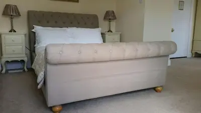 a large white bed with two night stands and two lamps at Pencubitt House in Liskeard