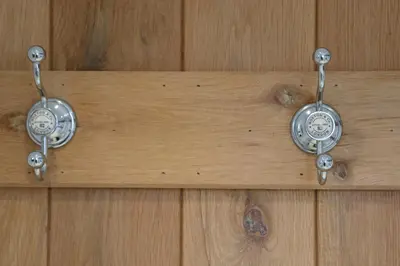 two clocks are hanging on a wooden wall at TOWN CENTRE contemporary cottage in Padstow