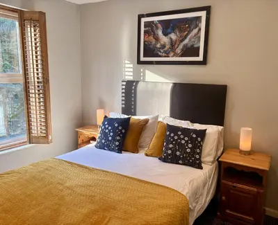 a bedroom with a bed with pillows on it at Penryn House Hotel in Polperro
