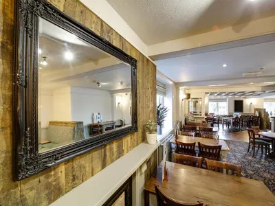a mirror on the wall of a restaurant at The Swan Hotel in Wadebridge