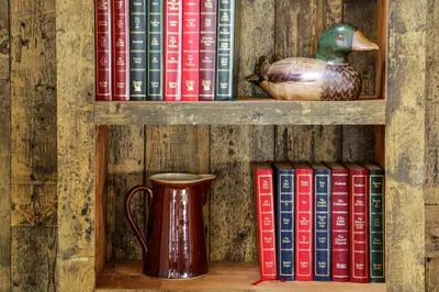 a book shelf filled with books and a vase at The Swan Hotel in Wadebridge