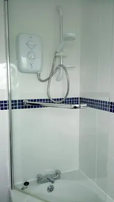 a shower in a bathroom with a sink at Chalet 18 Widemouth Bay Holiday Village in Bude