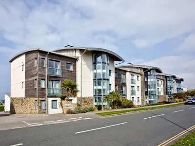 a row of apartment buildings on the side of a road at Apartment 7, Ocean 1 in Crantock