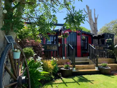 a house with a black gate and a garden at Stargazy Garden in Hayle
