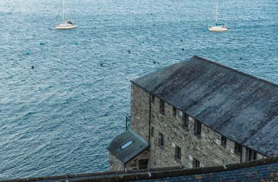 a building next to the water with boats in it at Star & Garter in Falmouth