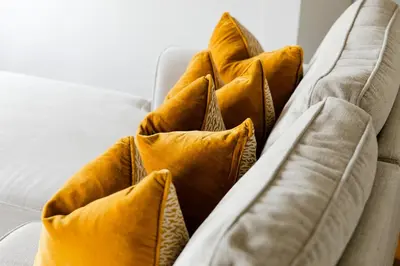 a group of yellow pillows on a couch at Star & Garter in Falmouth