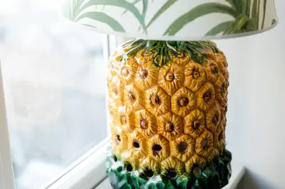 a pineapple vase with a lamp on a table at Star & Garter in Falmouth