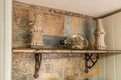 a wooden wall with a shelf with a glass ball on it at Deluxe Rustic Charlestown Themed Apartment in St Austell