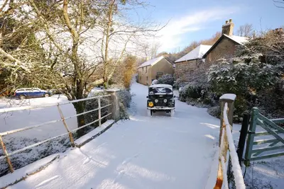 a jeep driving down a snow covered road at Bowgie at Trewerry Cottages - Away from it all, close to everywhere in Newquay