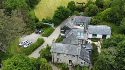 an aerial view of a house with cars parked in a driveway at Bowgie at Trewerry Cottages - Away from it all, close to everywhere in Newquay