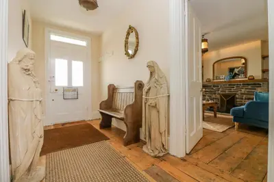 a living room with a statue in the middle of the room at 1 Dormer Villas in Porthscatho