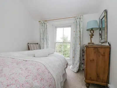 a bedroom with a bed and a window at Little Chycoose in Truro