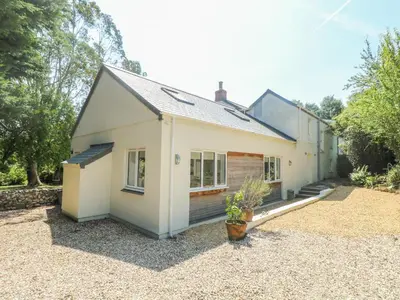 a white house with a gravel yard at Little Chycoose in Truro