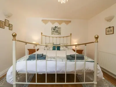 a bedroom with a metal bed in a room at Courtyard in Porthleven