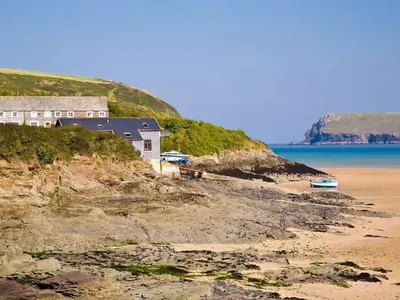 a house on a cliff next to the beach at The Old Dairy in Padstow