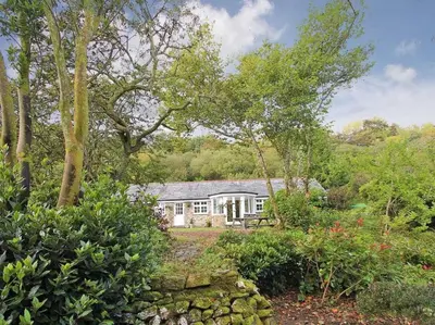 a house in the middle of a garden at Dairy Cottage in Bodmin