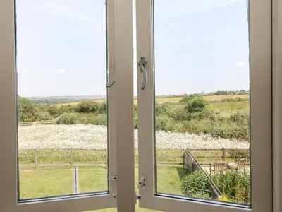 a window with a view of a field at Sundowner in Padstow