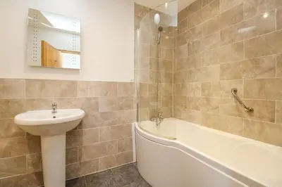 a bathroom with a sink and a toilet and a tub at Mill in Porthleven