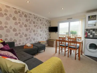 a living room with a couch and a table at Ocean Blue in Porthtowan