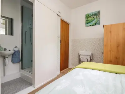 a bedroom with a bed and a sink at Withan Farm Wing in Manaccan