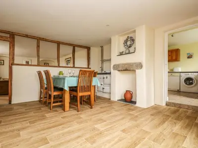 a kitchen and dining room with a table and chairs at Withan Farm Wing in Manaccan
